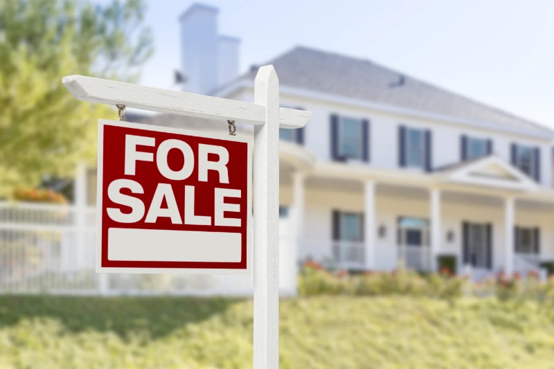 Home For Sale Real Estate Sign in Front of Beautiful New House